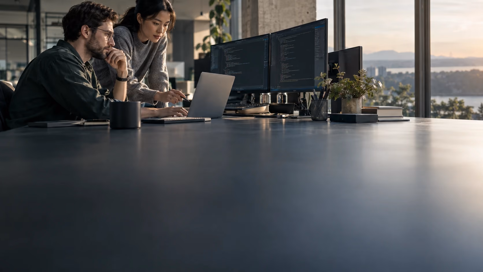 Two engineers collaborating at a workstation in a modern office.
